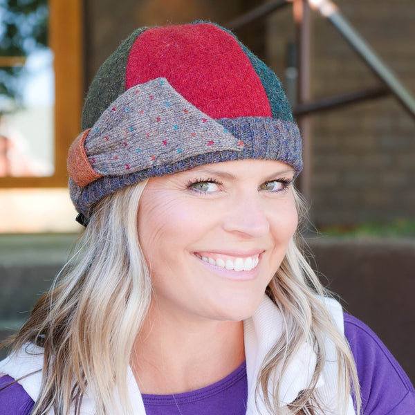 woman smiling wearing upcycled wool bow hat