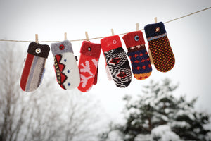 one of a kind sweater mittens on a clothesline
