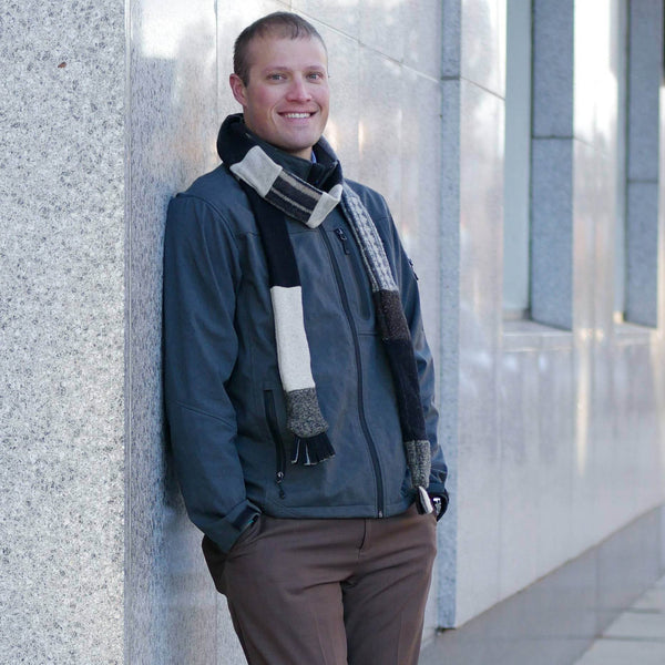 man standing wearing neutral colored skinny scarf