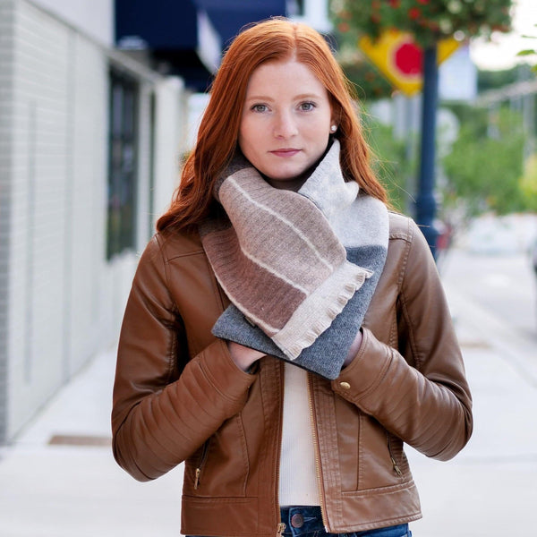 woman wearing a brown jacket and upcycled wool cowl scarf